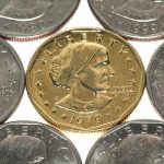 A collection of coins featuring a gold coin surrounded by silver coins