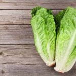 Parasite Panic Hits Beloved Fast Food Franchise Romaine lettuce hearts on rustic wooden table
