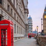 Hospitals Overrun As KILLER Heatwave Continues Red telephone box on a London street with clock tower in background