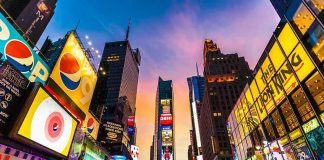 Times Square street with bright billboards at sunset