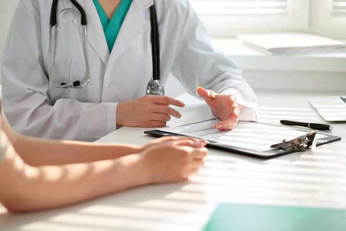 Doctor discusses medical notes with patient at a desk