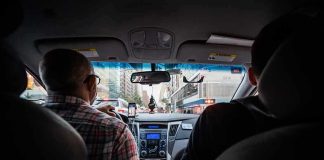 driver and passenger inside a car in city traffic