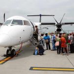 Passengers boarding a small aircraft at an airport