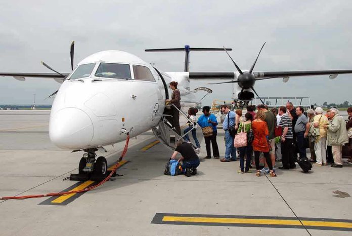 Passengers boarding a small aircraft at an airport