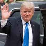 Trump’s Risky Russia Trade Upends Sanctions Donald Trump waves while standing beside a black vehicle