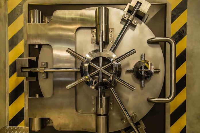 shutterstock_721230553 Vault door with steel locking wheel and handle