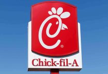 Chick-fil-A sign against clear blue sky
