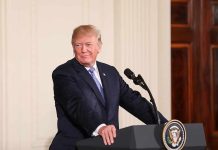 man at podium with presidential seal