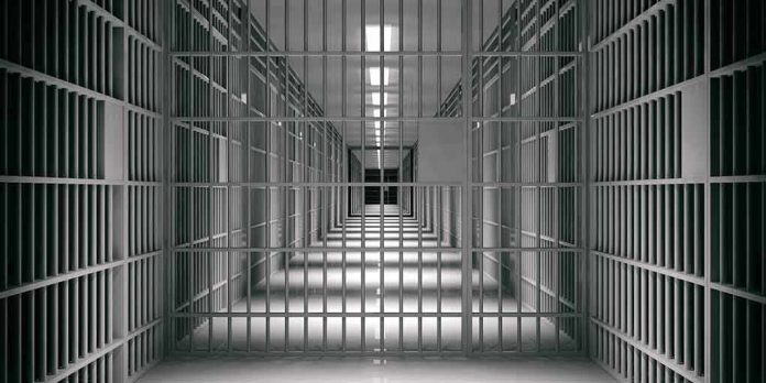 empty prison corridor with barred cells