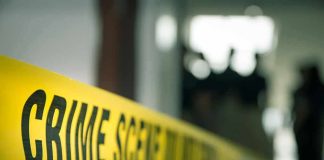Gypsy Rose Shocker: Partner Found Dead crime scene tape in a blurred indoor setting