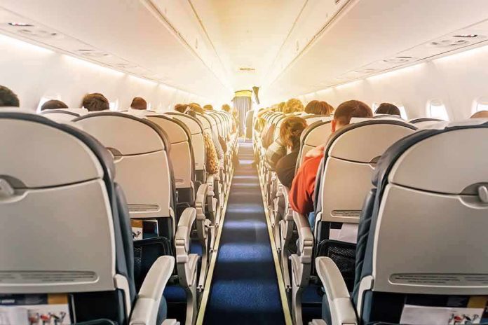 airplane cabin with passengers seated in economy class
