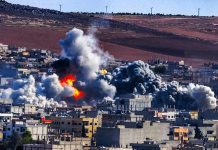 Urban explosion with thick smoke over city buildings
