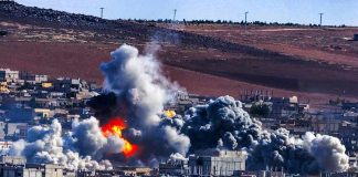 Houthis DESTROY Saudi Airport – Explosion Rocks Region Urban explosion with thick smoke over city buildings