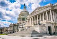 United States Capitol building with dome and columns under a partly cloudy sky