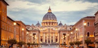 Vatican Bombshell: Pope’s Cancer Confirmed St. Peter's Basilica at the end of a wet street at dusk