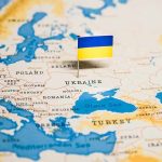 Ukraine flag pin on a map of Eastern Europe