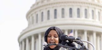 FBI Subpoena’s Ilhan Omars Family! Woman in hijab speaking at podium with microphones