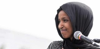 GOP Rep Reveals What They Found During Ilhan Omar Raid Ilhan Omar speaking at a microphone with hand on chest