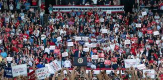 Trump Protester Gets Punched in the Face By MAGA Fan Tavon Wilson in a large crowd at a political rally