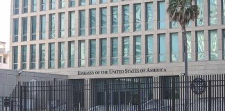 U.S Evacuates Diplomats Amid Missile Strikes Embassy building behind tall black security fence