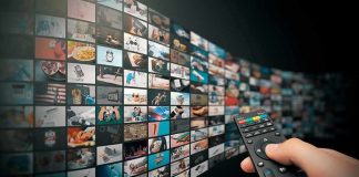 AI Worms Invading American Homes! Hand holding remote control facing a wall of streaming thumbnails