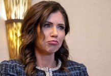 Woman with wavy brown hair making a pouting expression