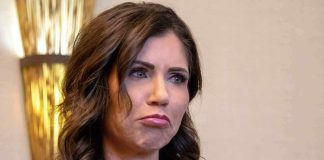 Woman with wavy brown hair making a pouting expression