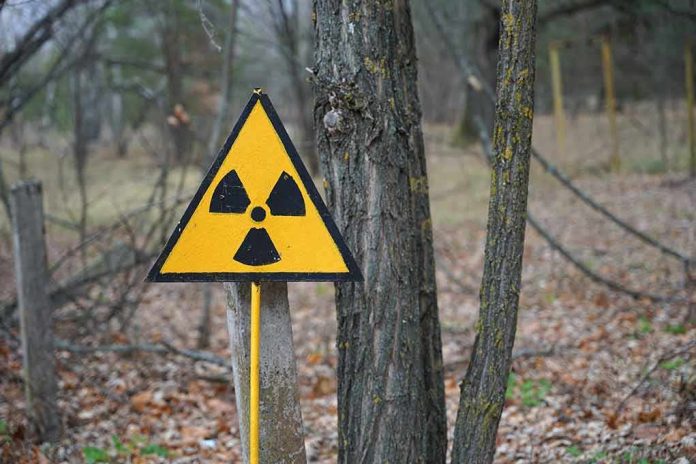 shutterstock_2128780223 radiation warning sign in a wooded area