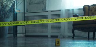 93-Year-Old Raped and Strangled By Illegal Crime scene tape across a room with evidence marker on floor