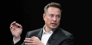 Musk Appointed TOP Pentagon Role – Even Gets an Office Elon Musk speaking in a black suit against a dark background