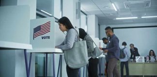 Voters at polling booths in a modern voting center