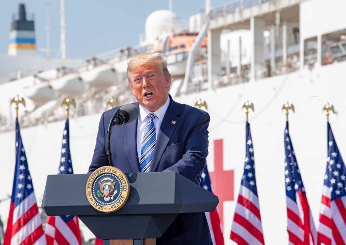 shutterstock_2599911507 Donald Trump speaking at a podium with American flags and a ship in the background