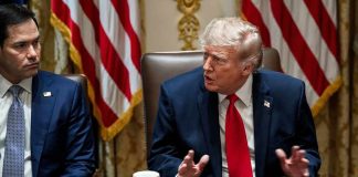 Trump Unleashes $8B Harvest Lifeline Donald Trump speaks at a meeting table beside Marco Rubio