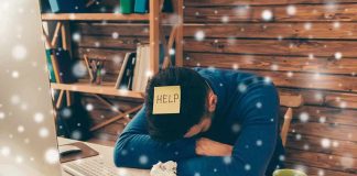 American Men Down Tools – Why Are So Many Unemployed? Person with head down at messy desk in home office