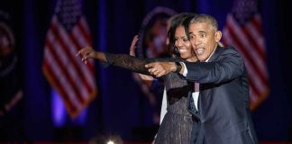 Michelle Obama and Rob Nabors pointing on stage at an event