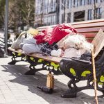 Person sleeping on park bench