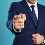 Man in a suit pointing finger