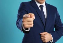 Man in a suit pointing finger