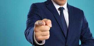 Man in a suit pointing finger