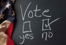 Chalkboard vote choice, "no" checked, American flag visible.