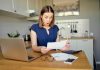 Woman shocked reading a document at home