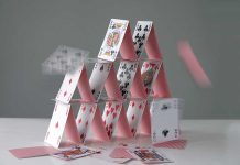 Collapsing house of cards in motion.