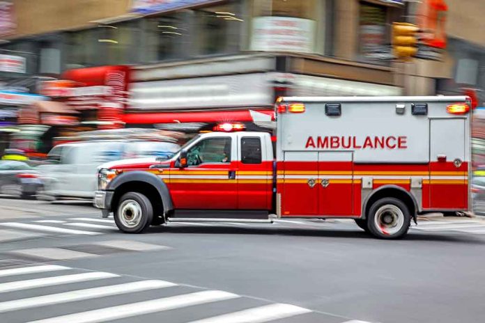 Ambulance speeding through city street intersection.