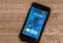 Incoming call labeled "SCAM" on smartphone screen.