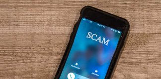 Incoming call labeled "SCAM" on smartphone screen.