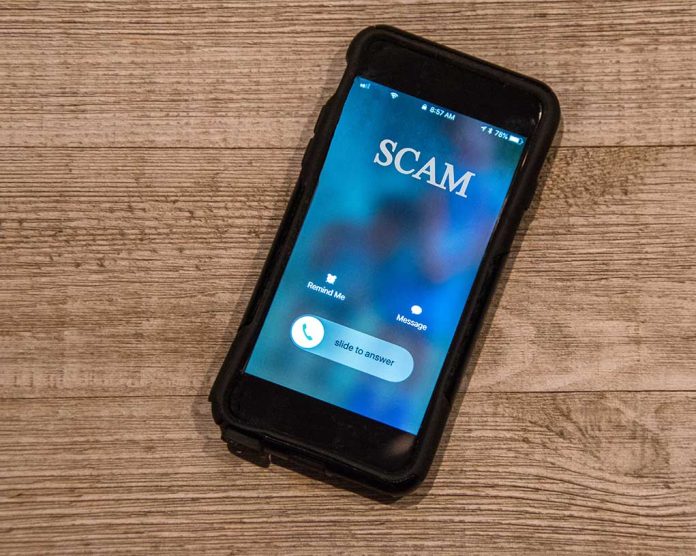 Incoming call labeled "SCAM" on smartphone screen.