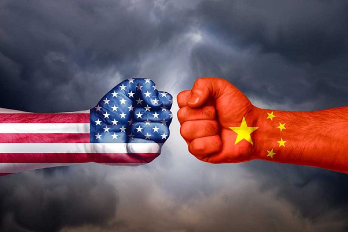 Fists painted like USA and China flags facing off