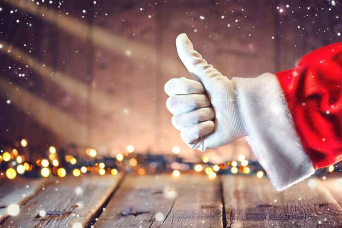 Santa hand giving thumbs up Christmas lights