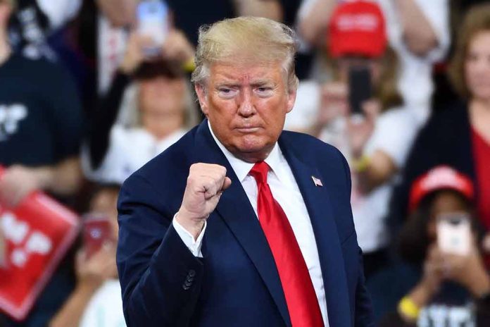 Man in suit making a fist gesture at rally.