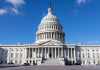 U.S. Capitol building under a clear blue sky.